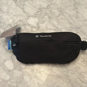 Therabody crossbody bag - filled with amazing travel products.